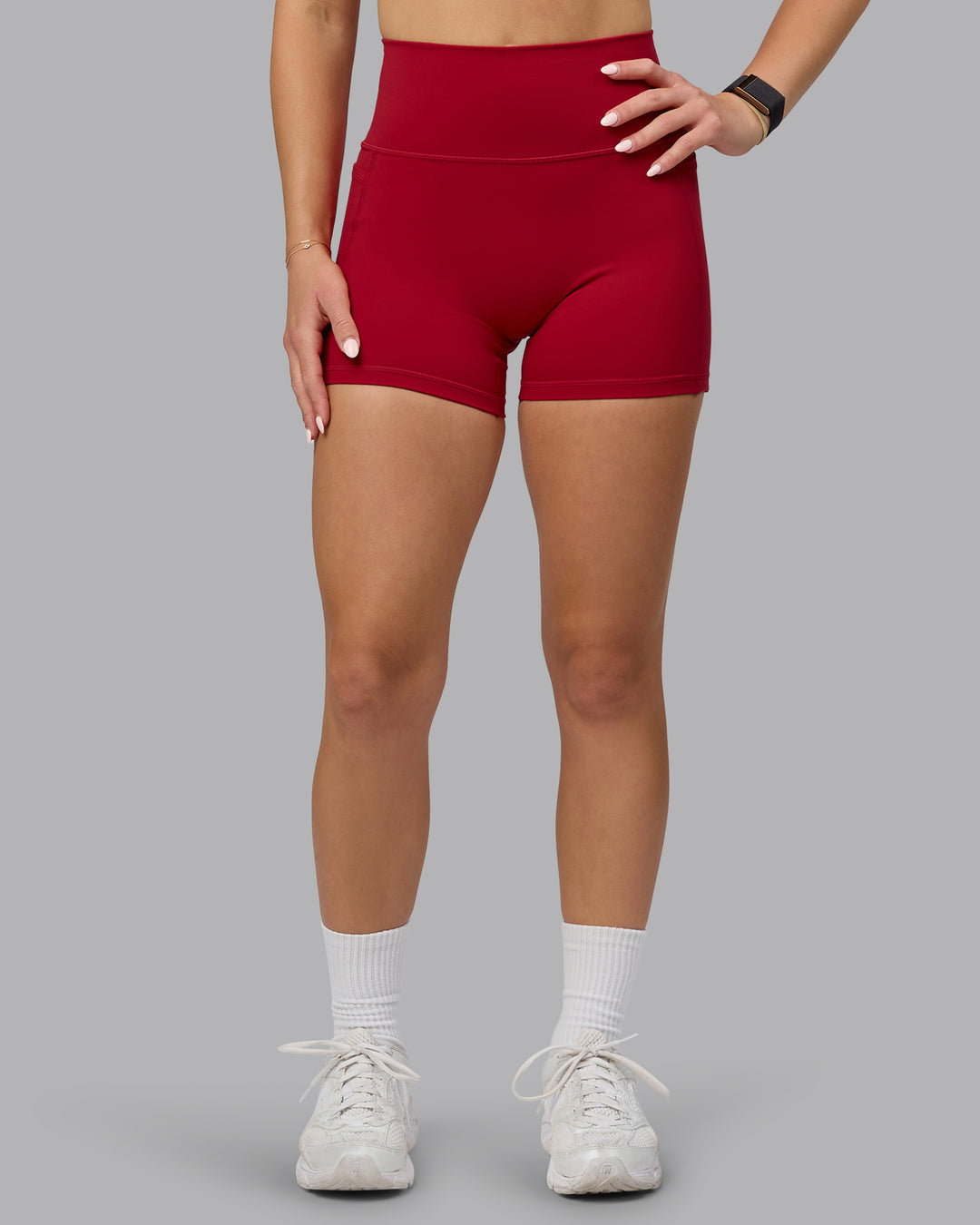 Woman wearing Fusion Ultra High-Rise 4" Short Pockets - Cherry Red | Model:Halle | Size:S