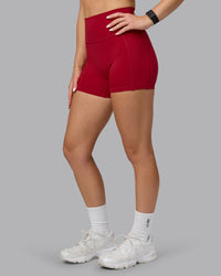 Woman wearing Fusion Ultra High-Rise 4" Short Pockets - Cherry Red | Model:Halle | Size:S