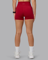 Woman wearing Fusion Ultra High-Rise 4" Short Pockets - Cherry Red | Model:Halle | Size:S