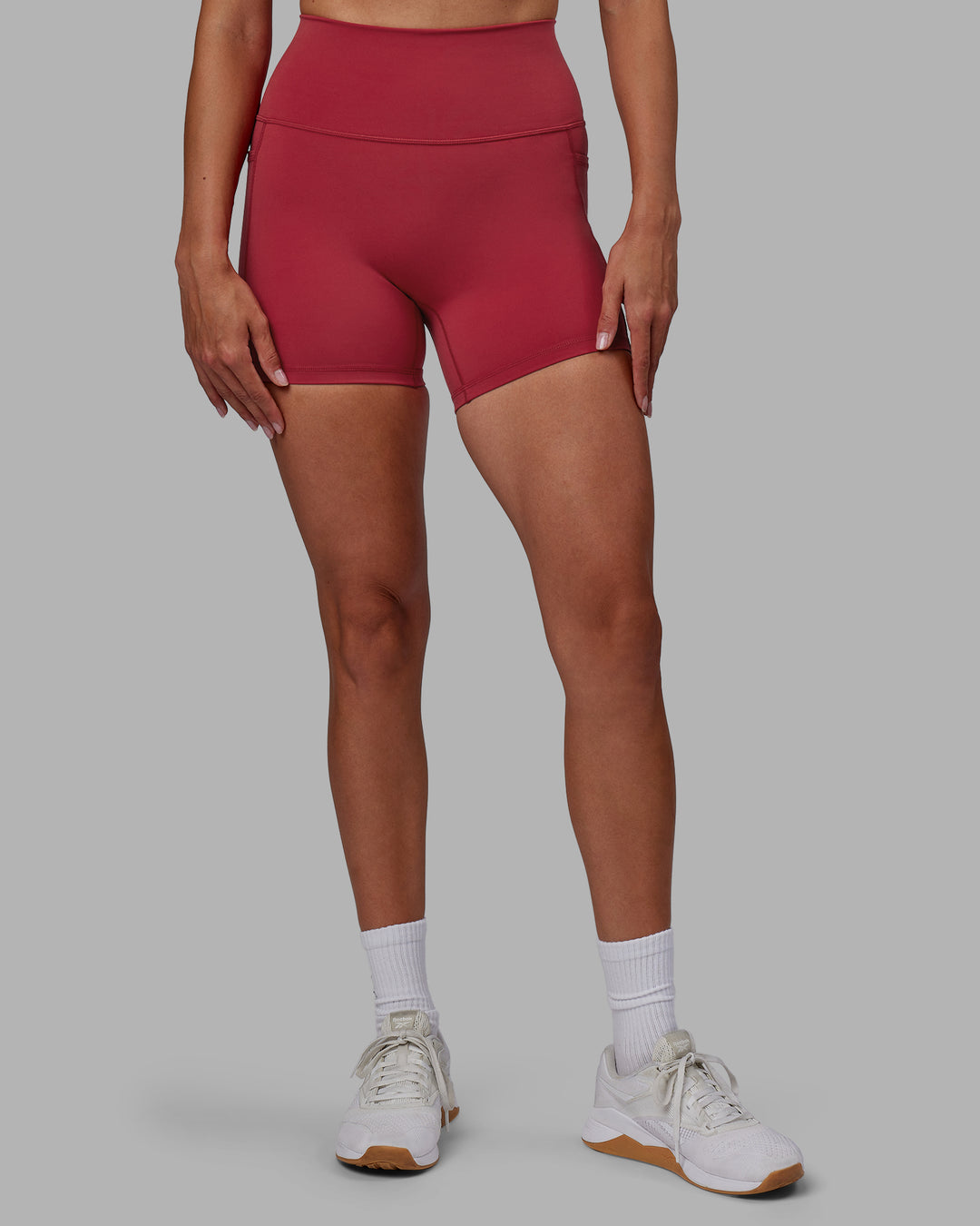 Woman wearing Fusion Ultra High-Rise 4&quot; Short Pockets - Claret | Model:Blaize | Size:S