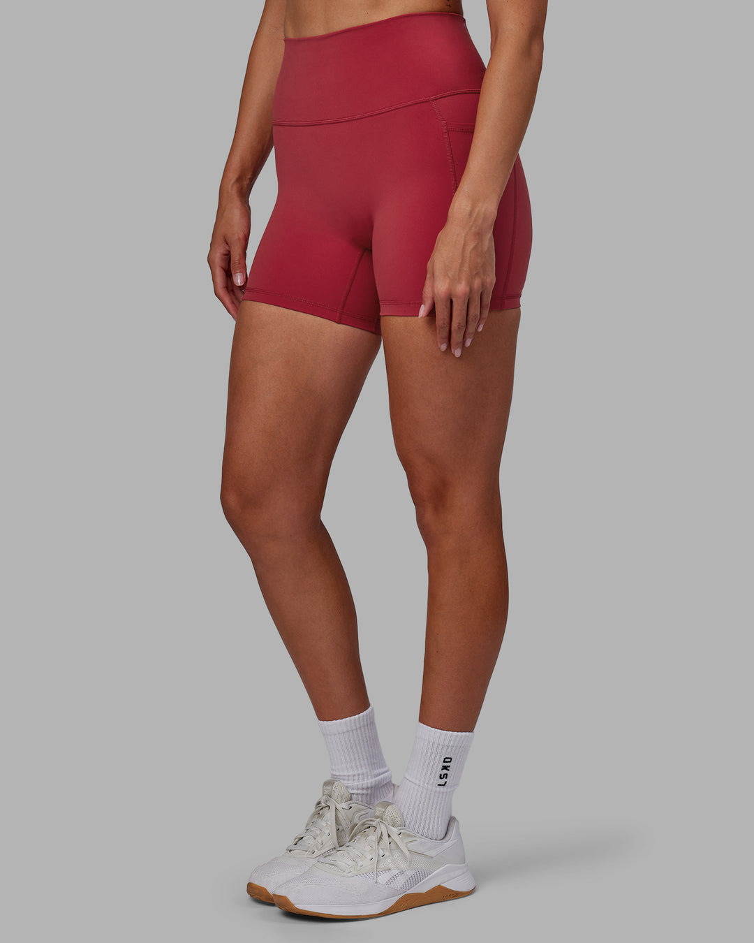 Woman wearing Fusion Ultra High-Rise 4&quot; Short Pockets - Claret | Model:Blaize | Size:S