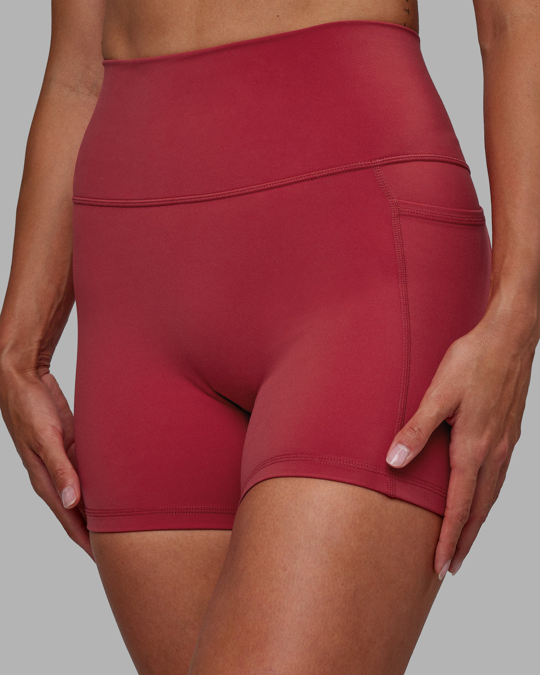 Woman wearing Fusion Ultra High-Rise 4&quot; Short Pockets - Claret | Model:Blaize | Size:S