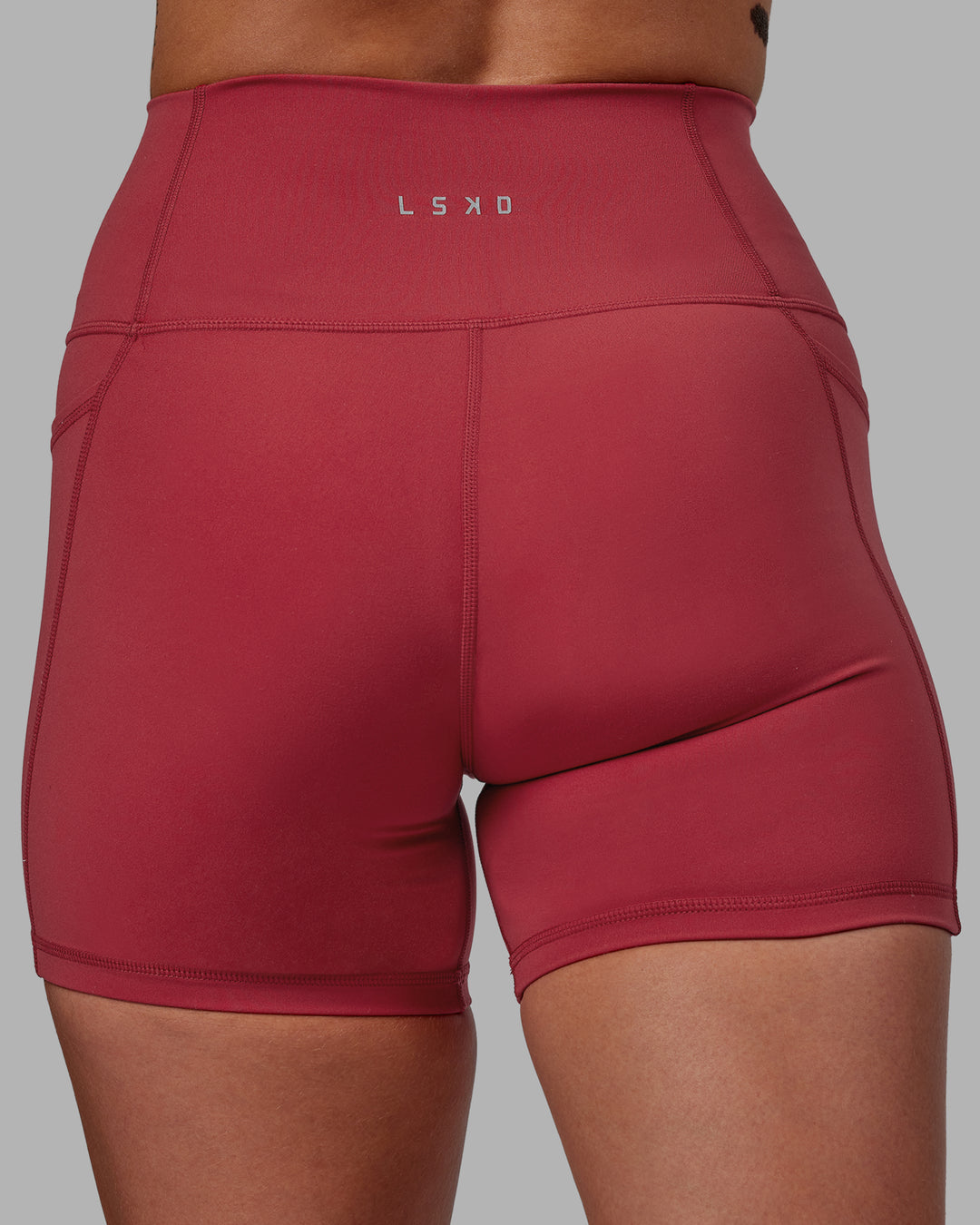 Woman wearing Fusion Ultra High-Rise 4&quot; Short Pockets - Claret | Model:Blaize | Size:S