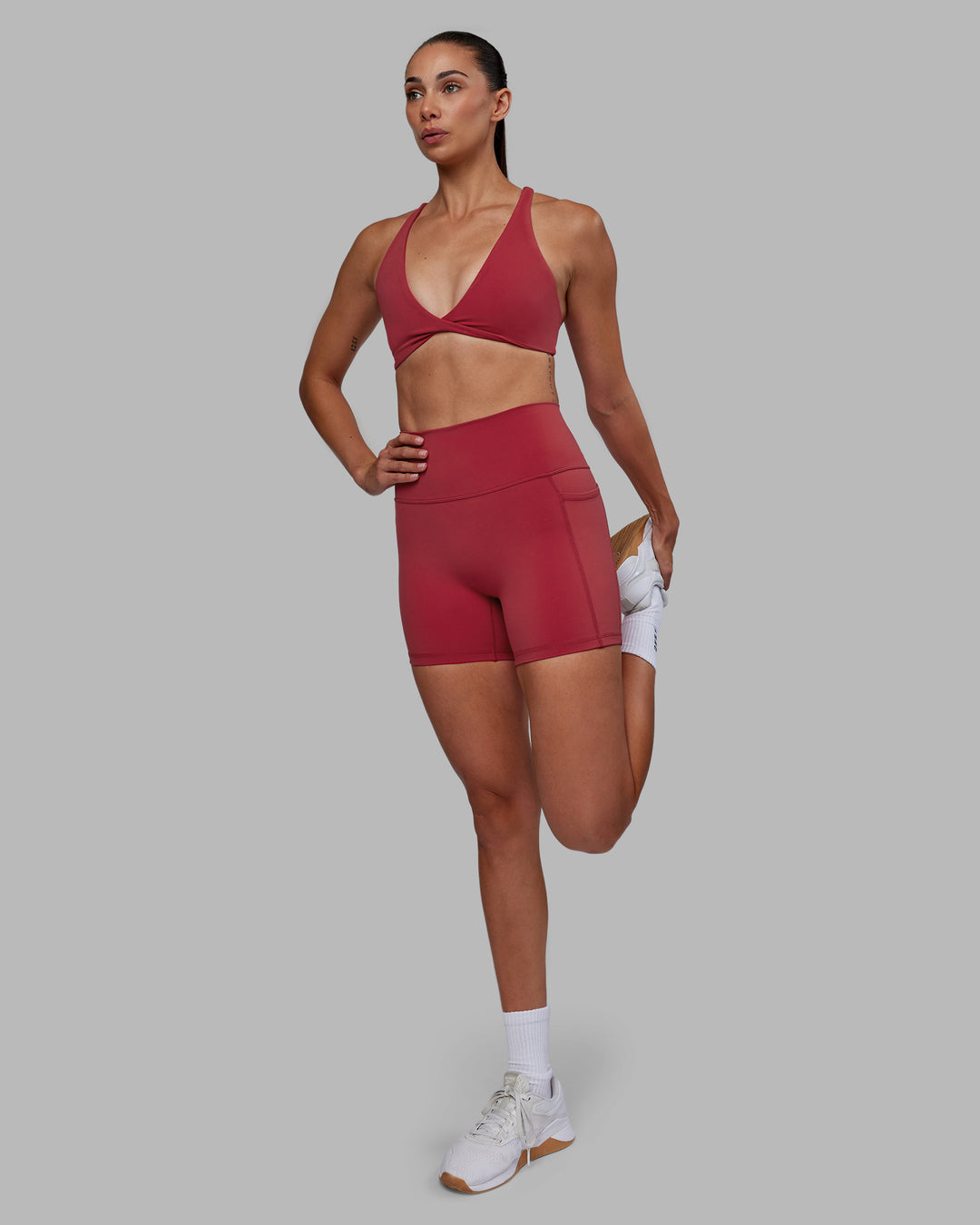 Woman wearing Fusion Ultra High-Rise 4&quot; Short Pockets - Claret | Model:Blaize | Size:S
