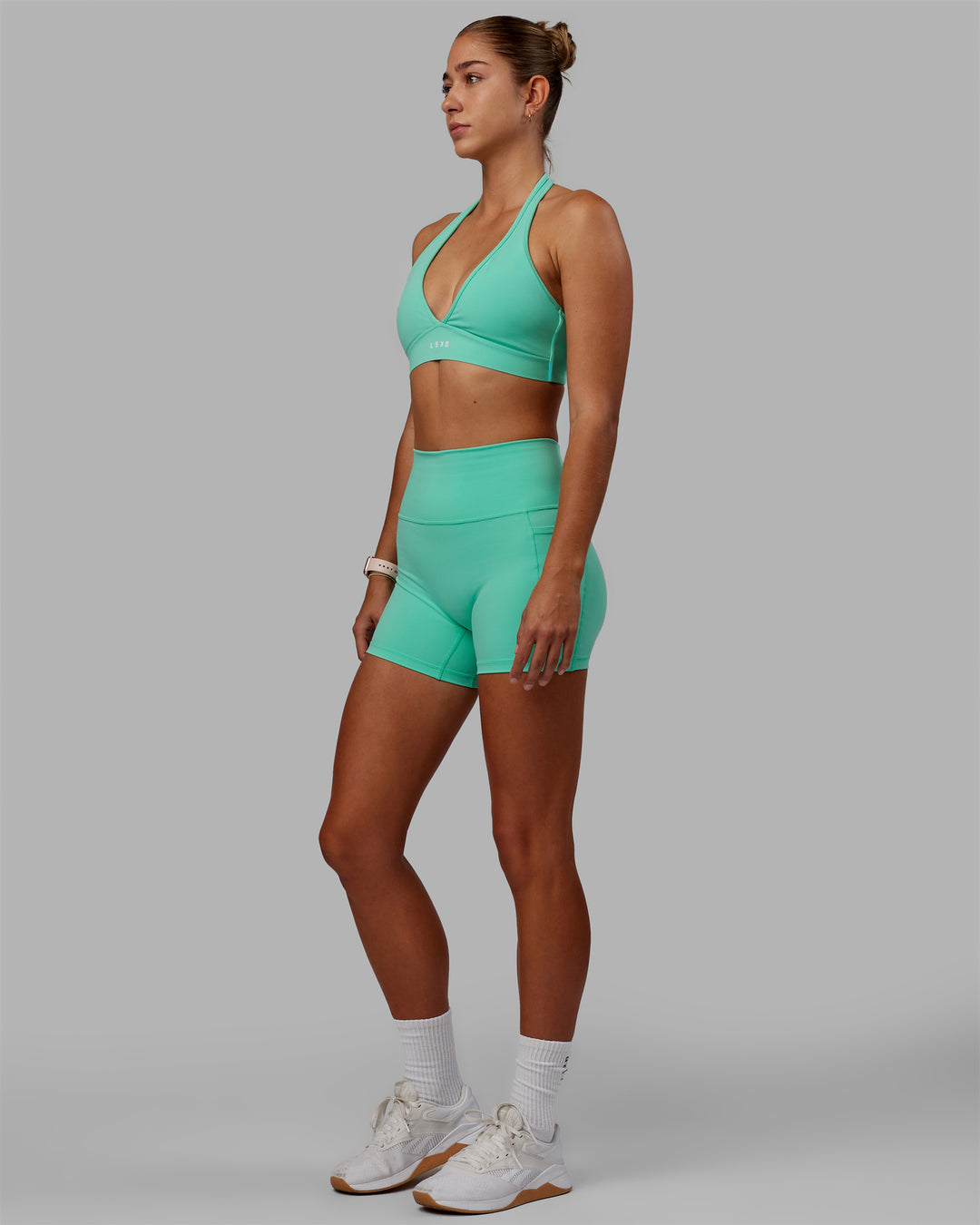 Woman wearing Fusion Ultra High-Rise 4&quot; Short Pockets - Cockatoo | Model:Asia | Size:S