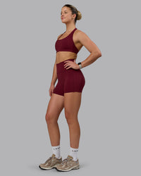Woman wearing Fusion Ultra High-Rise 4" Short Pockets - Cordovan | Model:Chloe | Size:XS