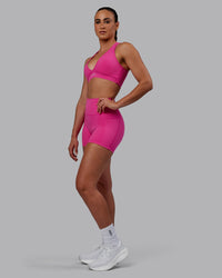 Woman wearing Fusion Ultra High-Rise 4" Short Pockets - Fuchsia Pink | Model:Sophie | Size:S