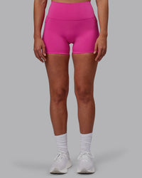 Woman wearing Fusion Ultra High-Rise 4" Short Pockets - Fuchsia Pink | Model:Sophie | Size:S