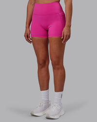 Woman wearing Fusion Ultra High-Rise 4" Short Pockets - Fuchsia Pink | Model:Sophie | Size:S