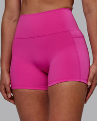 Woman wearing Fusion Ultra High-Rise 4" Short Pockets - Fuchsia Pink | Model:Sophie | Size:S