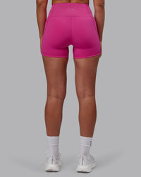 Woman wearing Fusion Ultra High-Rise 4" Short Pockets - Fuchsia Pink | Model:Sophie | Size:S