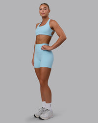 Woman wearing Fusion Ultra High-Rise 4" Short Pockets - Glacial Blue | Model:Monique | Size:S