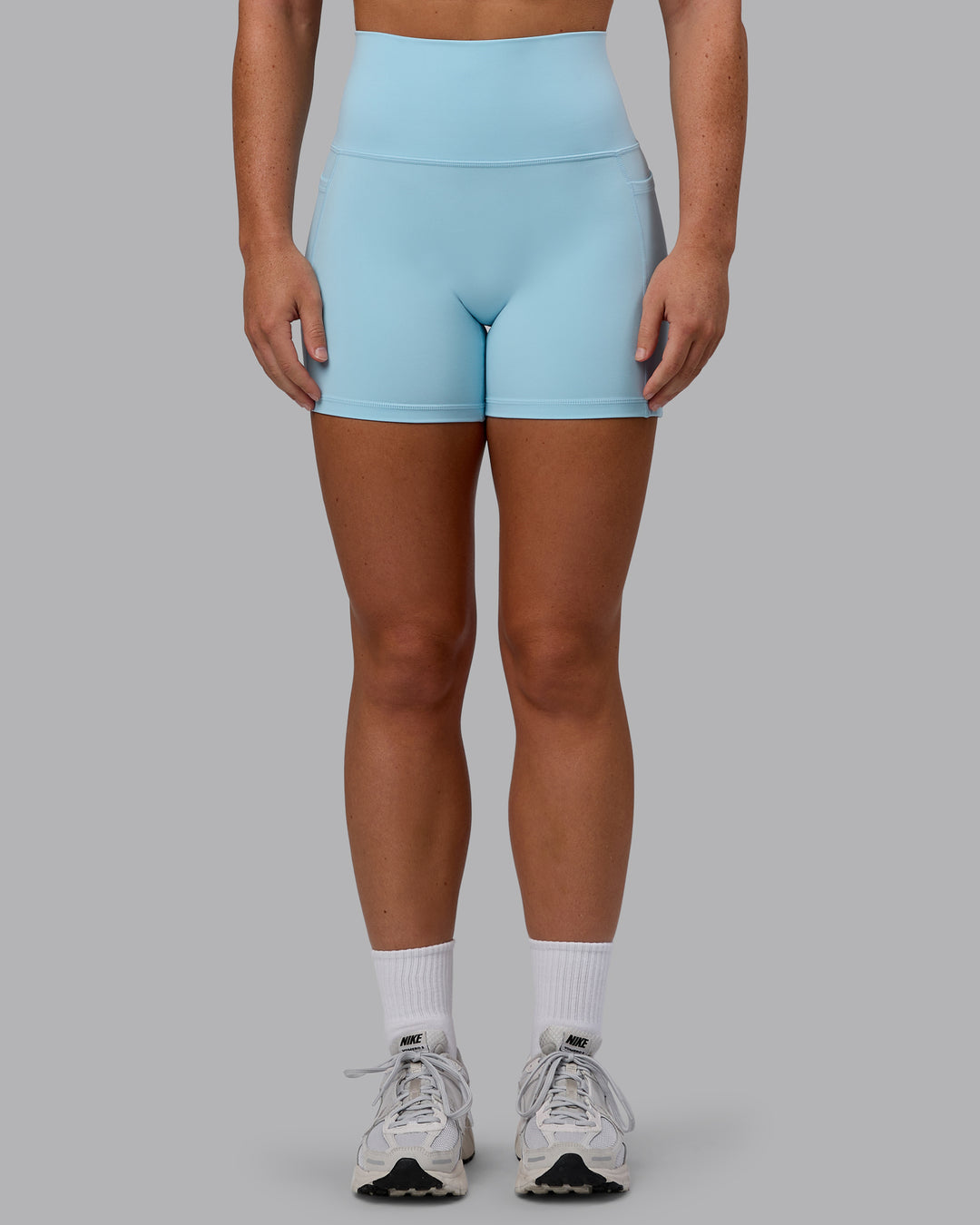 Woman wearing Fusion Ultra High-Rise 4&quot; Short Pockets - Glacial Blue | Model:Monique | Size:S
