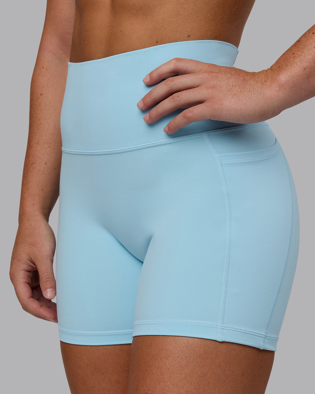 Woman wearing Fusion Ultra High-Rise 4&quot; Short Pockets - Glacial Blue | Model:Monique | Size:S
