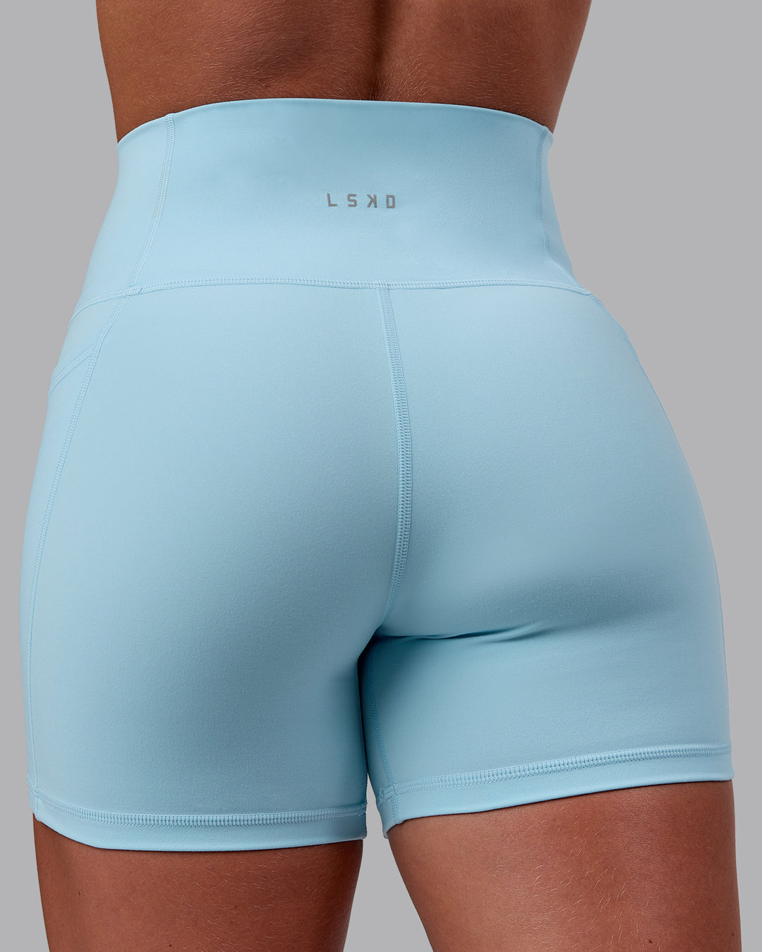 Woman wearing Fusion Ultra High-Rise 4&quot; Short Pockets - Glacial Blue | Model:Monique | Size:S