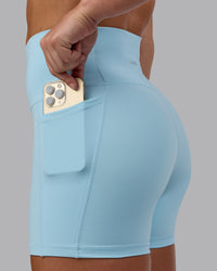 Woman wearing Fusion Ultra High-Rise 4" Short Pockets - Glacial Blue | Model:Monique | Size:S