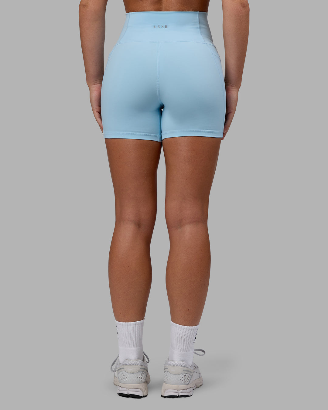 Woman wearing Fusion Ultra High-Rise 4&quot; Short Pockets - Glacial Blue | Model:Monique | Size:S