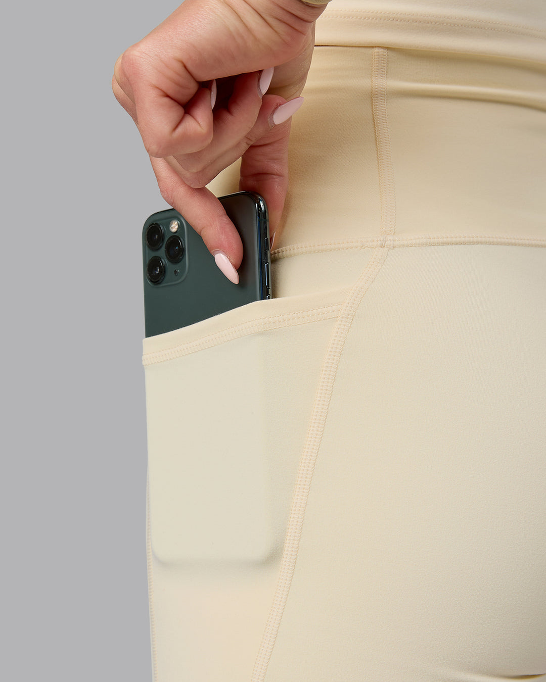 Woman wearing Fusion Ultra High-Rise 4&quot; Short Pockets - Ivory | Model:Halle | Size:S