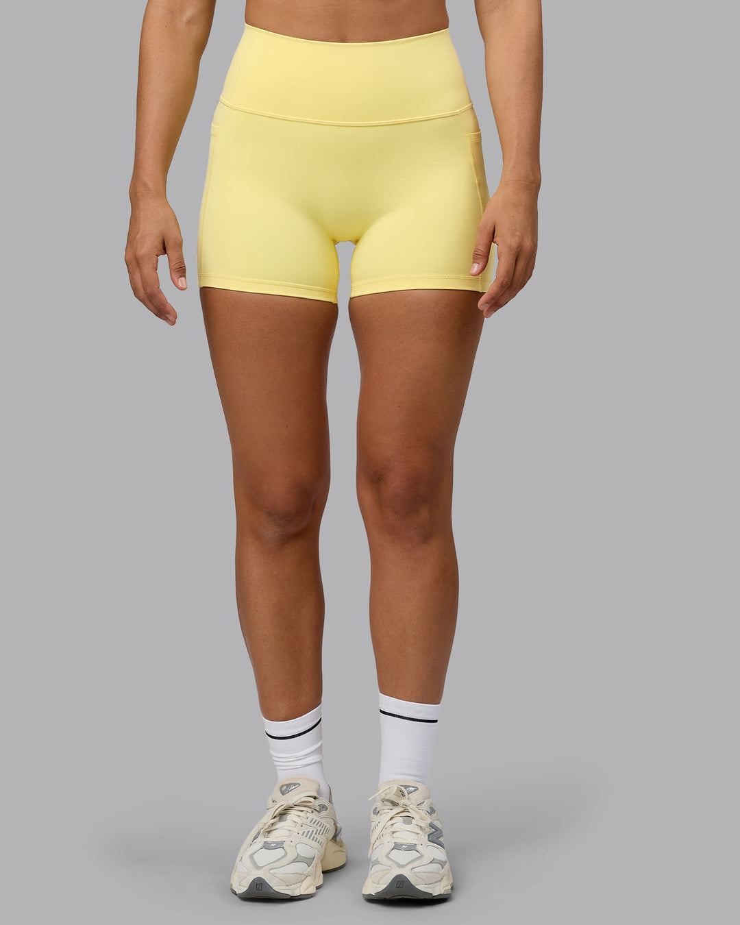 Woman wearing Fusion Ultra High-Rise 4&quot; Short Pockets - Lemon | Model:Sophie | Size:S