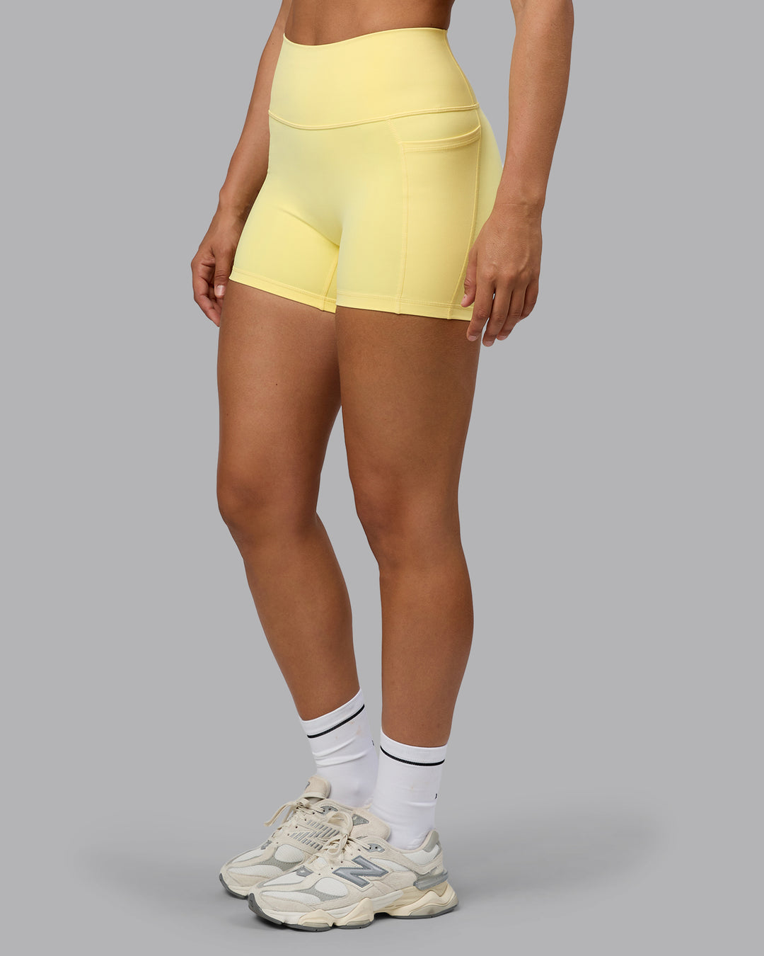 Woman wearing Fusion Ultra High-Rise 4&quot; Short Pockets - Lemon | Model:Sophie | Size:S