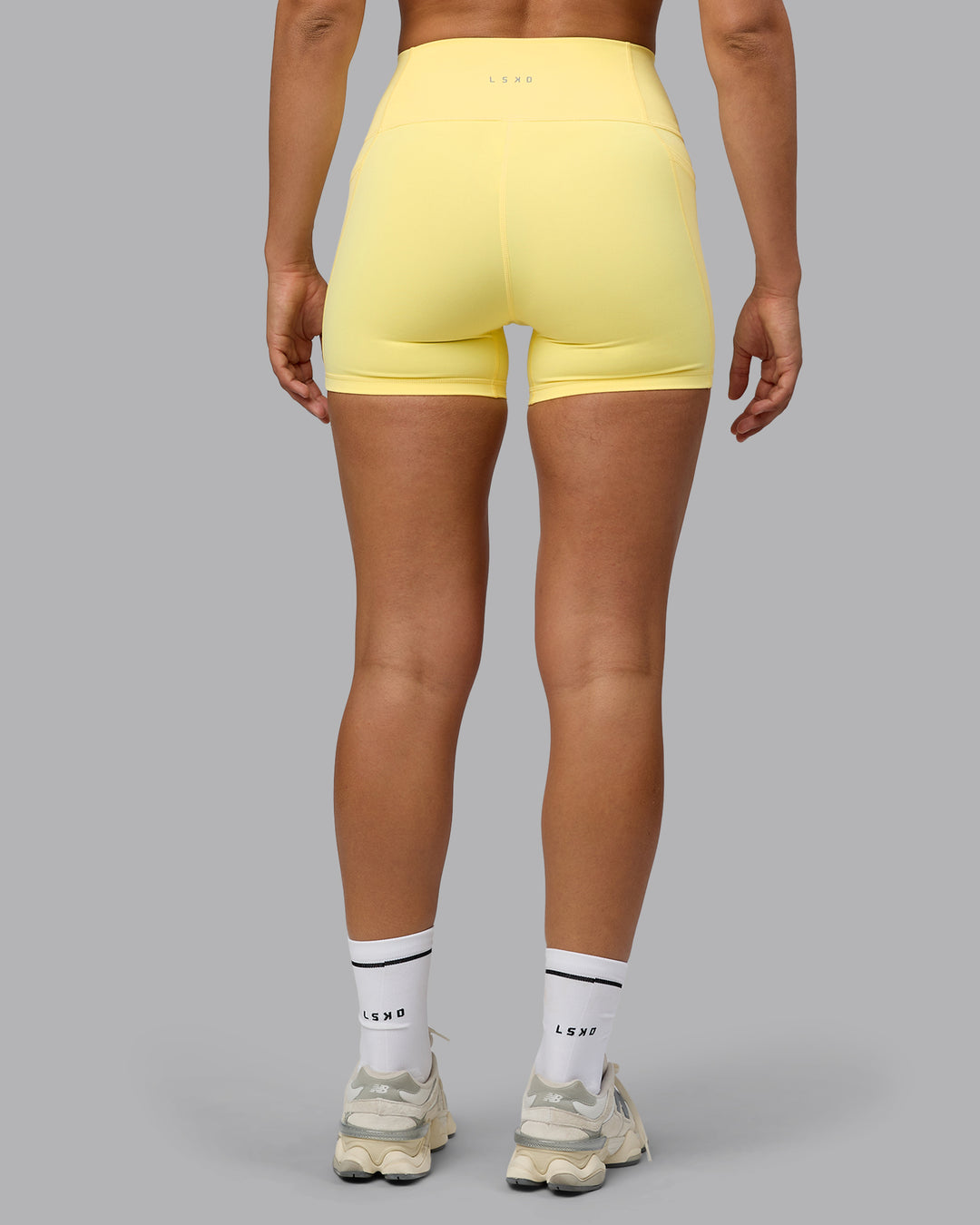 Woman wearing Fusion Ultra High-Rise 4&quot; Short Pockets - Lemon | Model:Sophie | Size:S