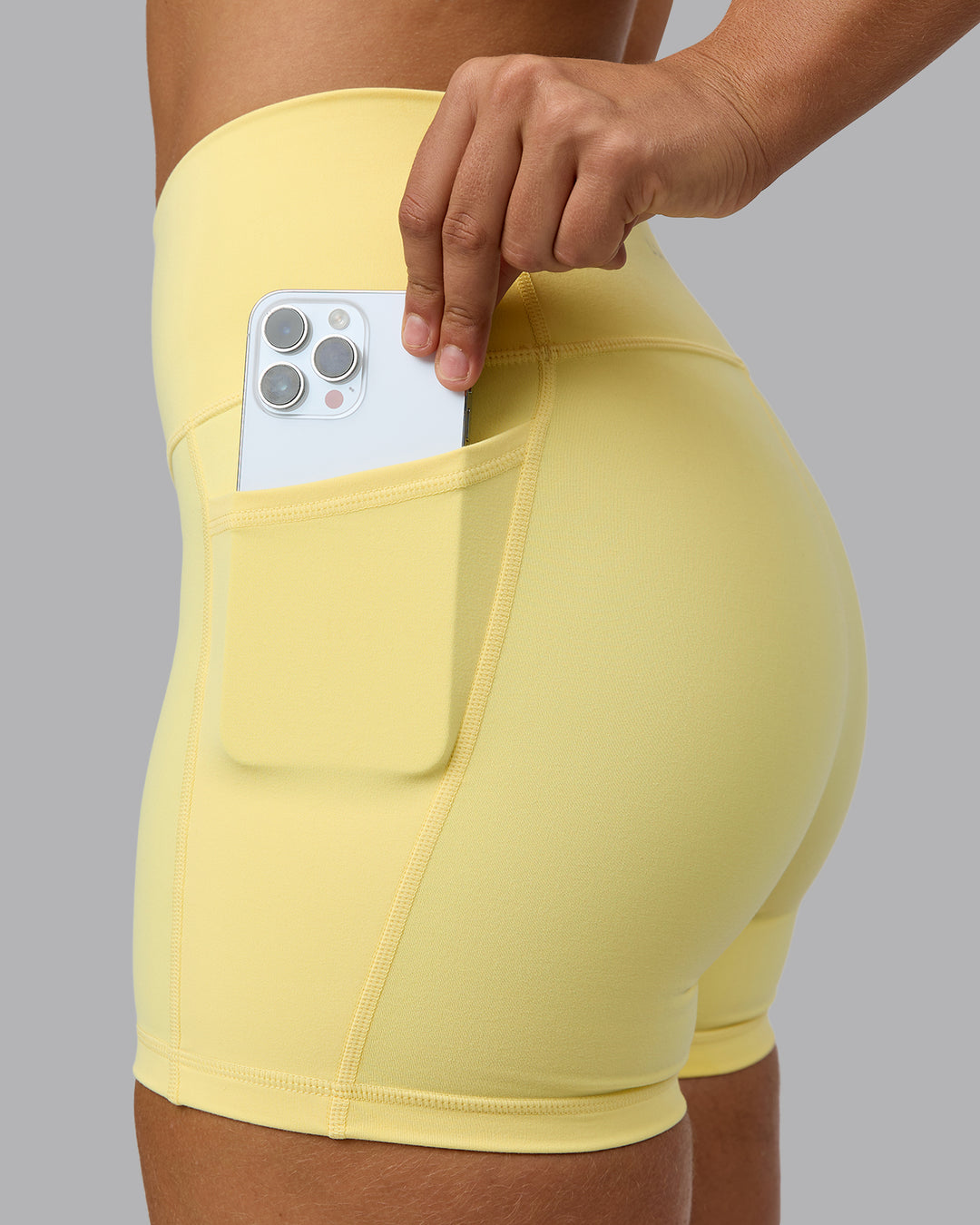 Woman wearing Fusion Ultra High-Rise 4" Short Pockets - Lemon | Model:Sophie | Size:S