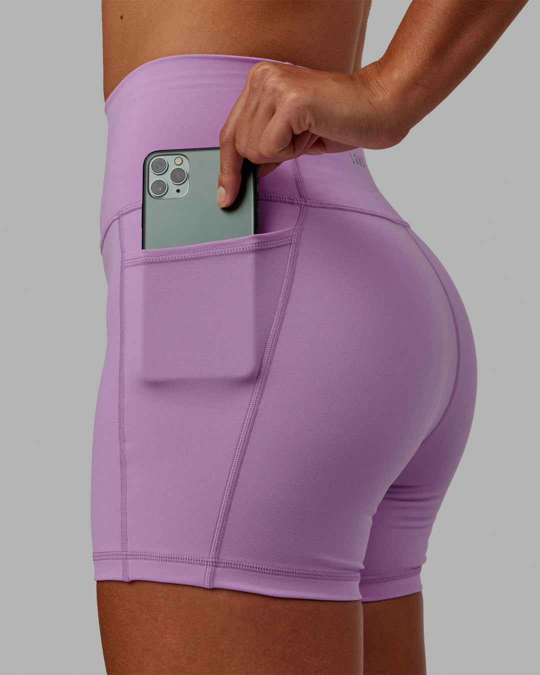 Woman wearing Fusion Ultra High-Rise 4&quot; Short Pockets - Light Violet | Model:Asia | Size:S