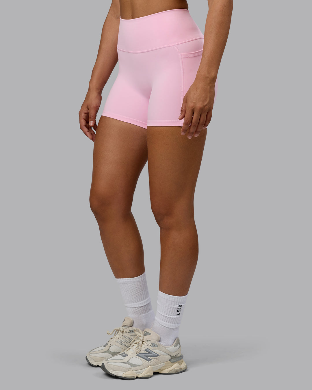 Woman wearing Fusion Ultra High-Rise 4" Short Pockets - Pale Pink | Model:Sophie | Size:S
