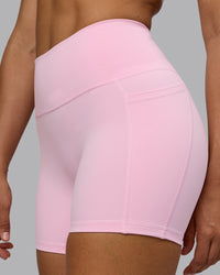 Woman wearing Fusion Ultra High-Rise 4" Short Pockets - Pale Pink | Model:Sophie | Size:S