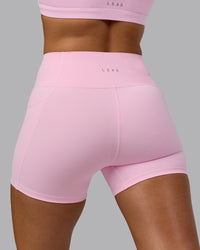 Woman wearing Fusion Ultra High-Rise 4" Short Pockets - Pale Pink | Model:Sophie | Size:S