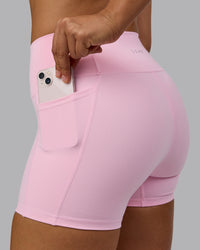 Woman wearing Fusion Ultra High-Rise 4" Short Pockets - Pale Pink | Model:Sophie | Size:S