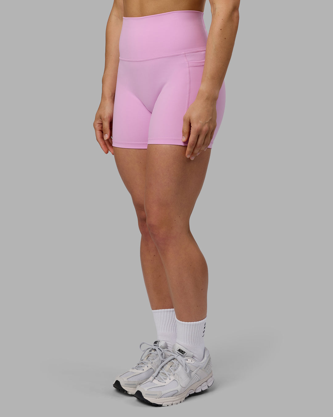 Woman wearing Fusion Ultra High-Rise 4&quot; Short Pockets - Pastel Orchid | Model:Zoe | Size:S