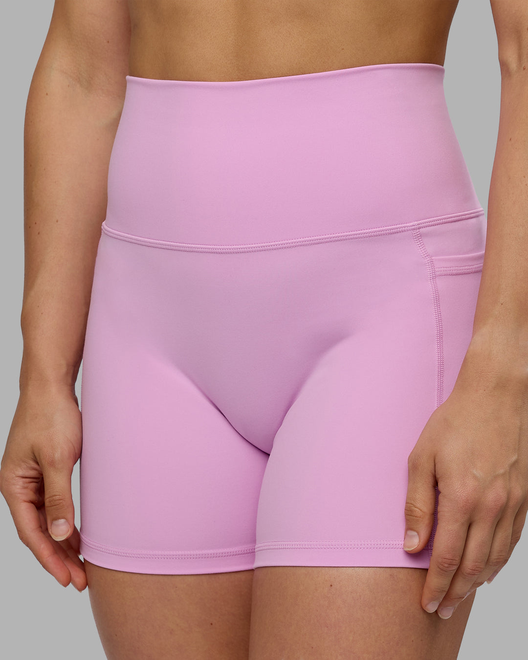 Woman wearing Fusion Ultra High-Rise 4&quot; Short Pockets - Pastel Orchid | Model:Zoe | Size:S