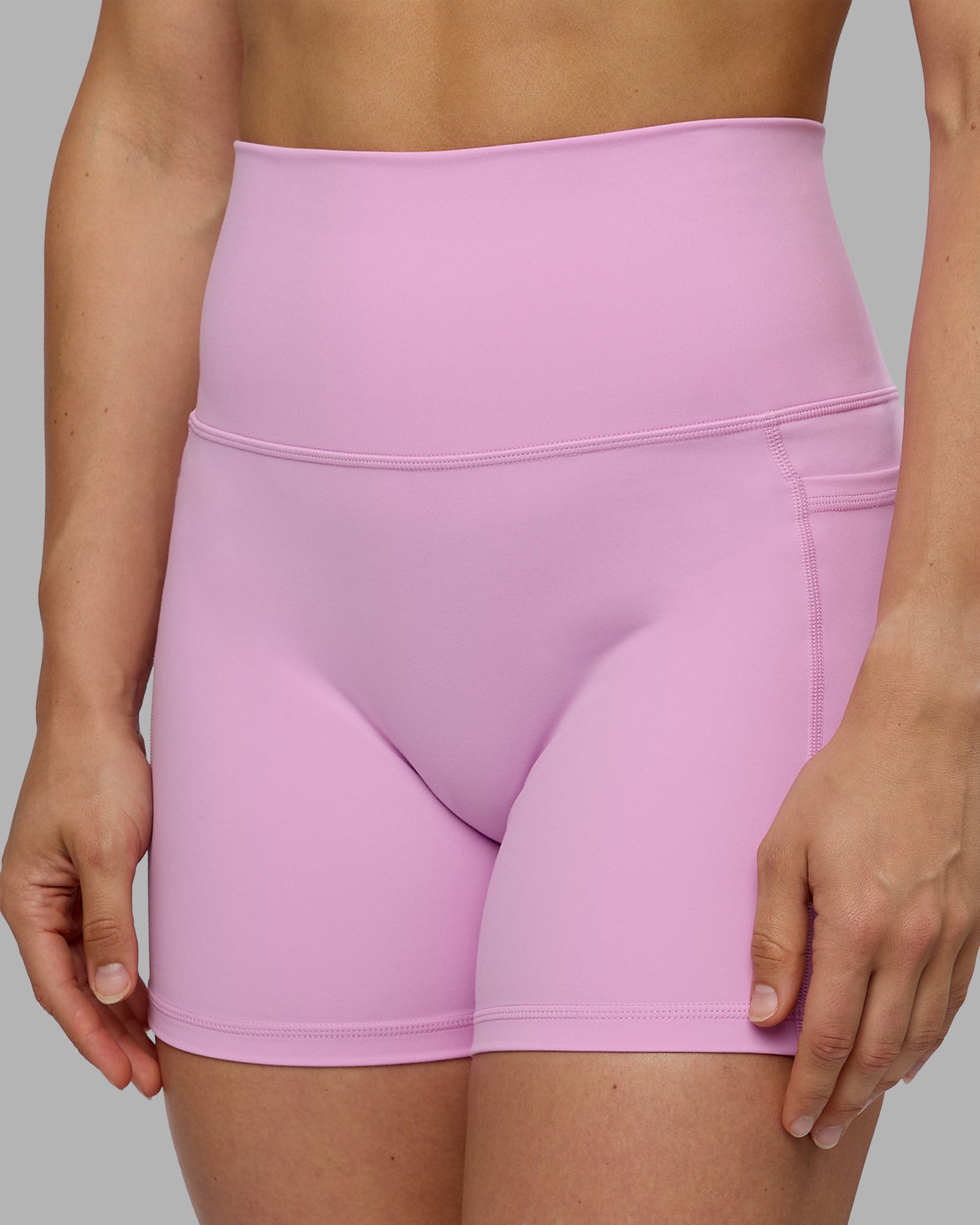 Woman wearing Fusion Ultra High-Rise 4" Short Pockets - Pastel Orchid | Model:Zoe | Size:S