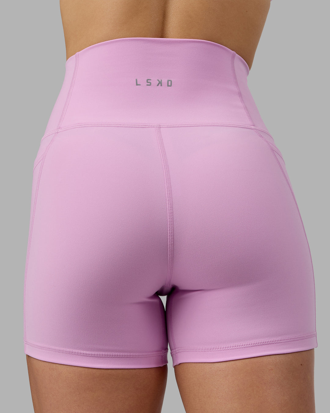 Woman wearing Fusion Ultra High-Rise 4&quot; Short Pockets - Pastel Orchid | Model:Zoe | Size:S