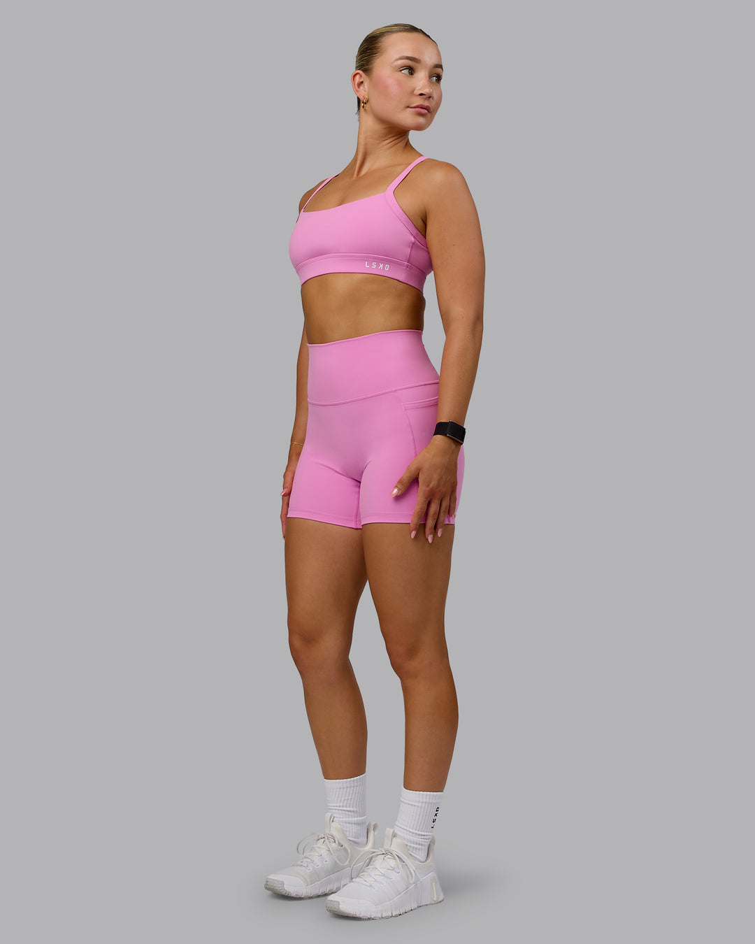 Woman wearing Fusion Ultra High-Rise 4&quot; Short Pockets - Spark Pink | Model:Halle | Size:S