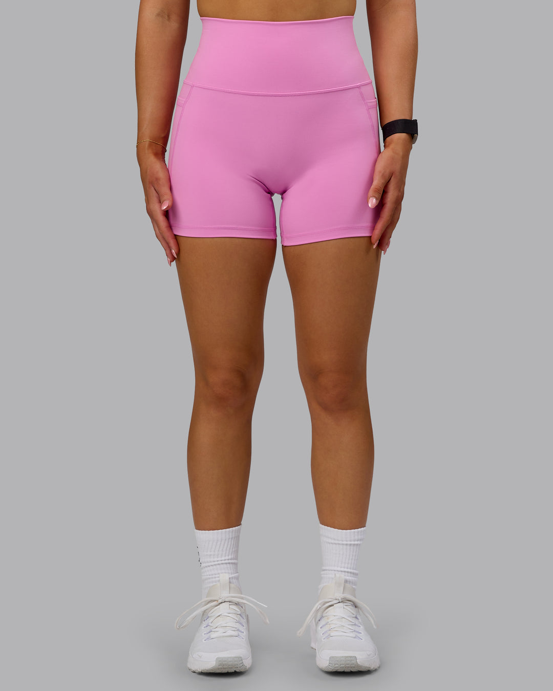 Woman wearing Fusion Ultra High-Rise 4&quot; Short Pockets - Spark Pink | Model:Halle | Size:S