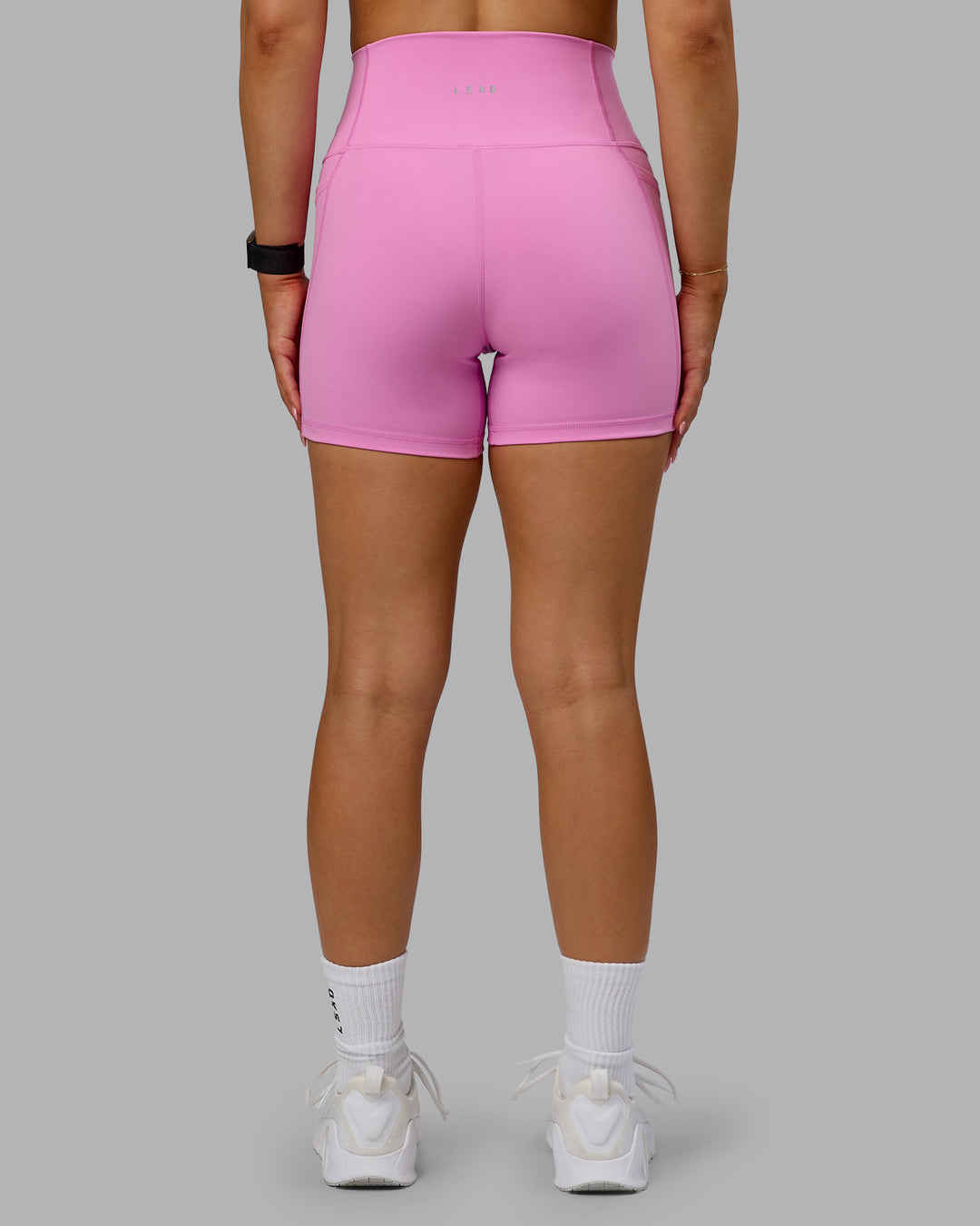 Woman wearing Fusion Ultra High-Rise 4&quot; Short Pockets - Spark Pink | Model:Halle | Size:S