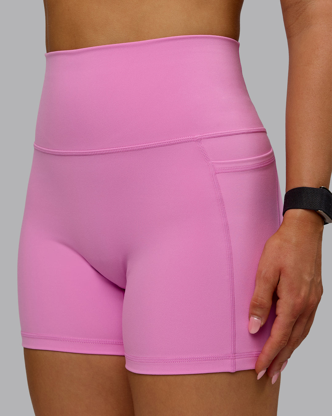 Woman wearing Fusion Ultra High-Rise 4&quot; Short Pockets - Spark Pink | Model:Halle | Size:S