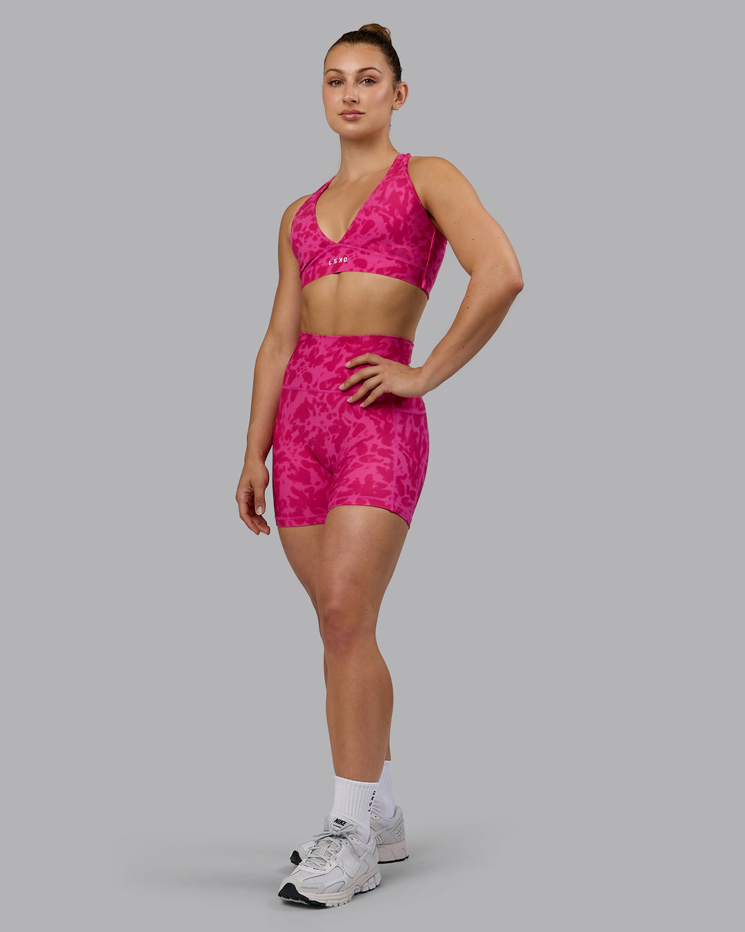 Woman wearing Fusion Ultra High-Rise 4&quot; Short Pockets - Strawberry-Lava Lamp | Model:Zoe | Size:S