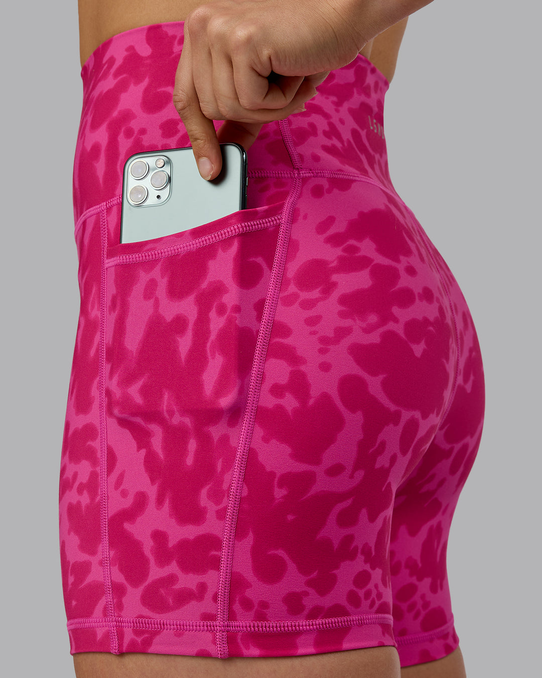 Woman wearing Fusion Ultra High-Rise 4&quot; Short Pockets - Strawberry-Lava Lamp | Model:Zoe | Size:S