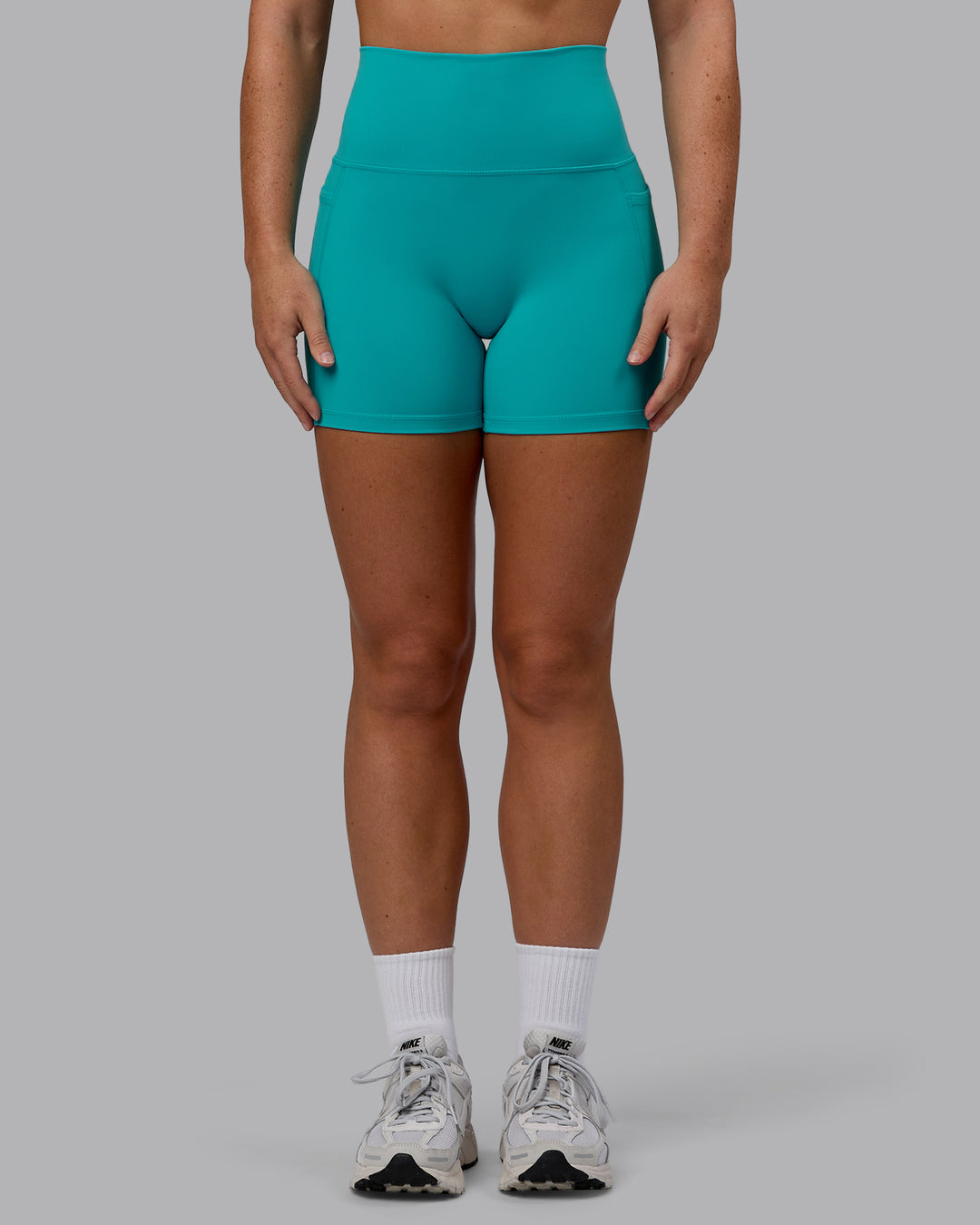 Woman wearing Fusion Ultra High-Rise 4&quot; Short Pockets - Uplift Blue | Model:Monique | Size:S
