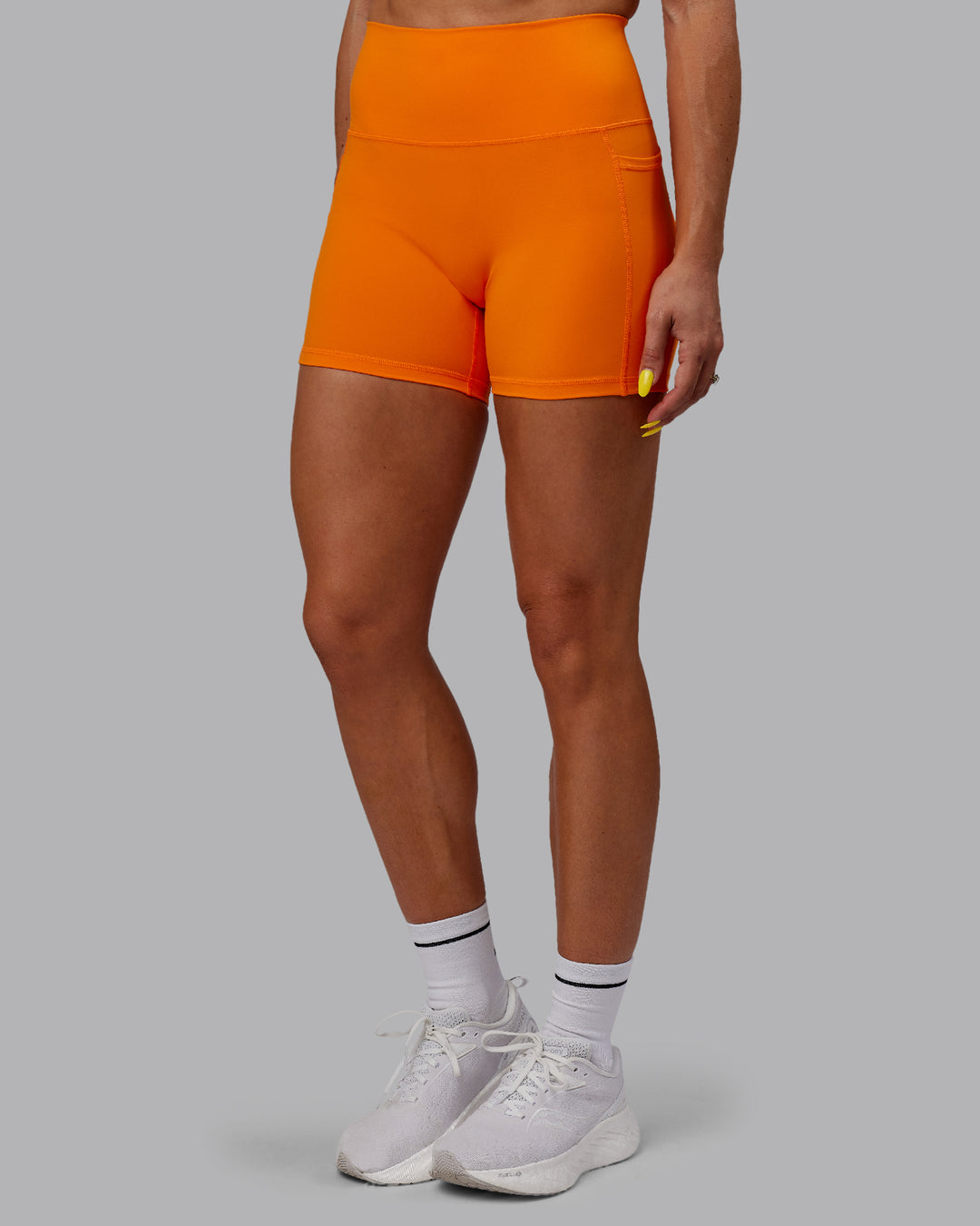 Woman wearing Fusion Ultra High-Rise 4&quot; Short Pockets - Vibrant Orange | Model:Bree | Size:S