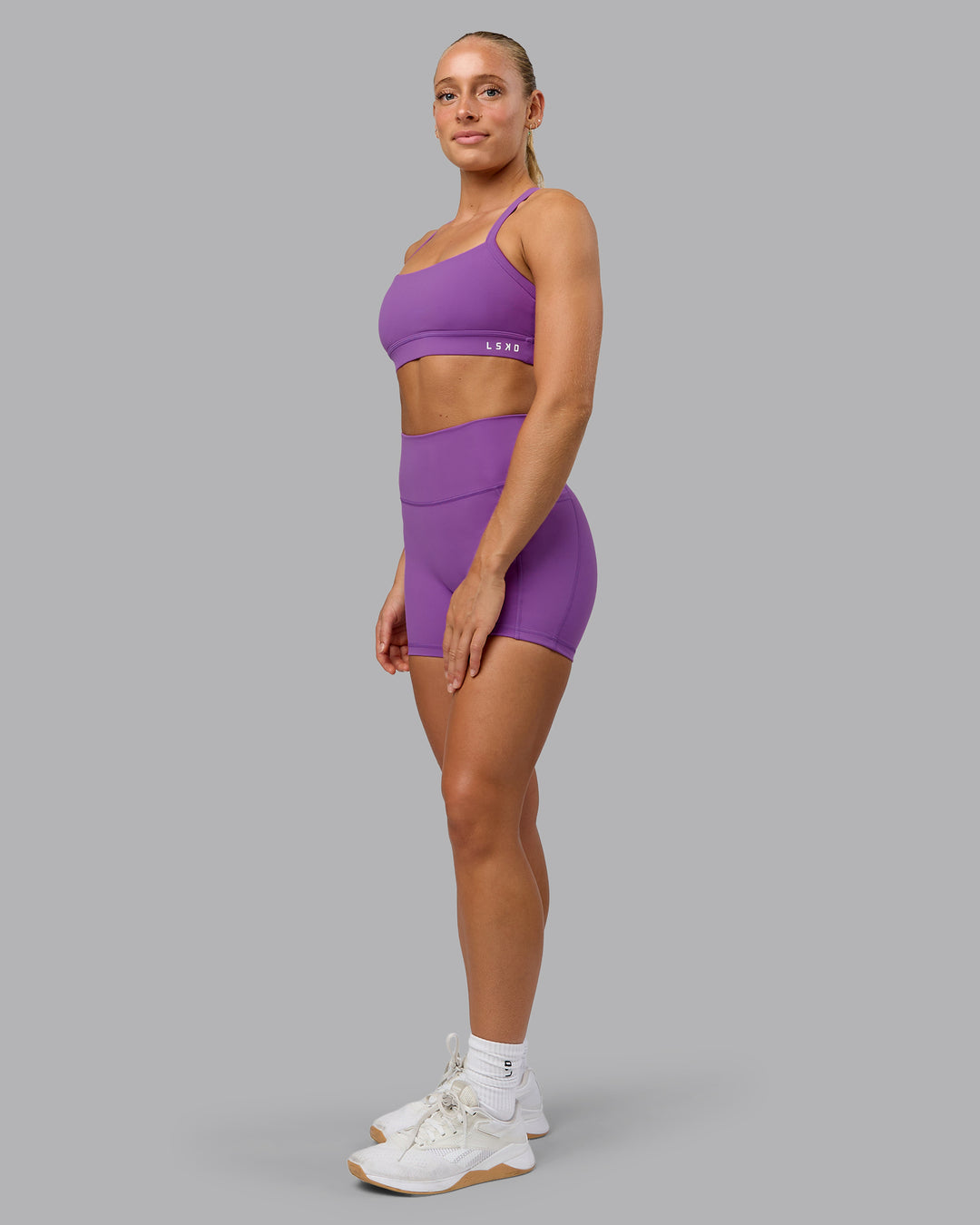Woman wearing Fusion Ultra High-Rise 4&quot; Short Pockets - Purple Fizz | Model:Shalem | Size:S