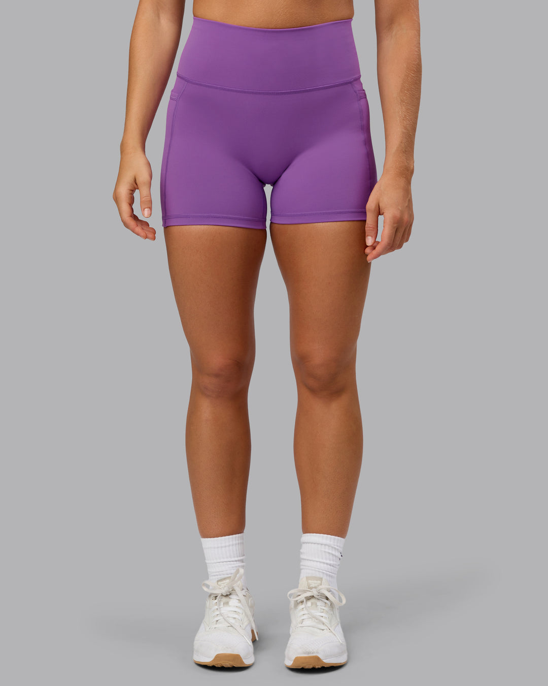 Woman wearing Fusion Ultra High-Rise 4&quot; Short Pockets - Purple Fizz | Model:Shalem | Size:S