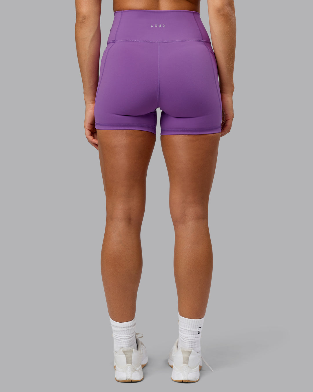 Woman wearing Fusion Ultra High-Rise 4&quot; Short Pockets - Purple Fizz | Model:Shalem | Size:S