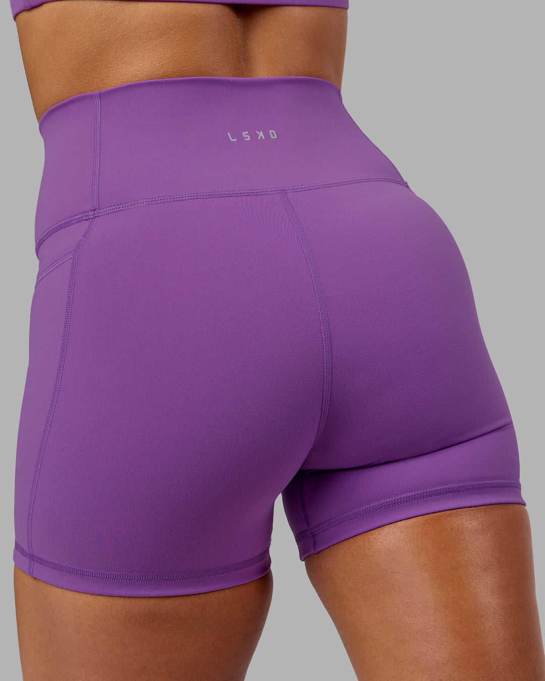 Woman wearing Fusion Ultra High-Rise 4&quot; Short Pockets - Purple Fizz | Model:Shalem | Size:S