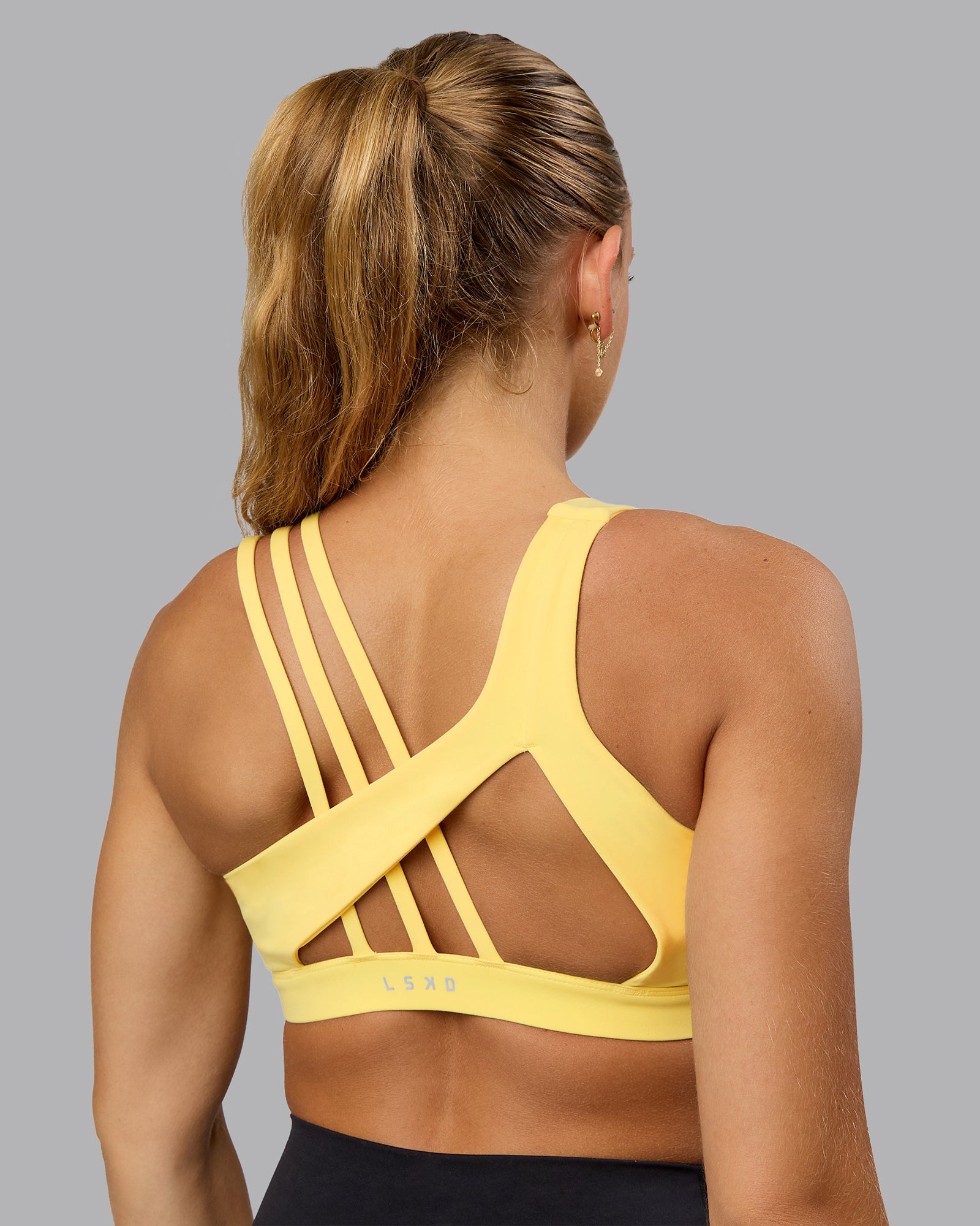 Woman wearing Galvanise Sports Bra - Lemon