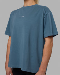 Woman wearing Go-To FLXCotton Oversized Tee - Elemental Blue-White