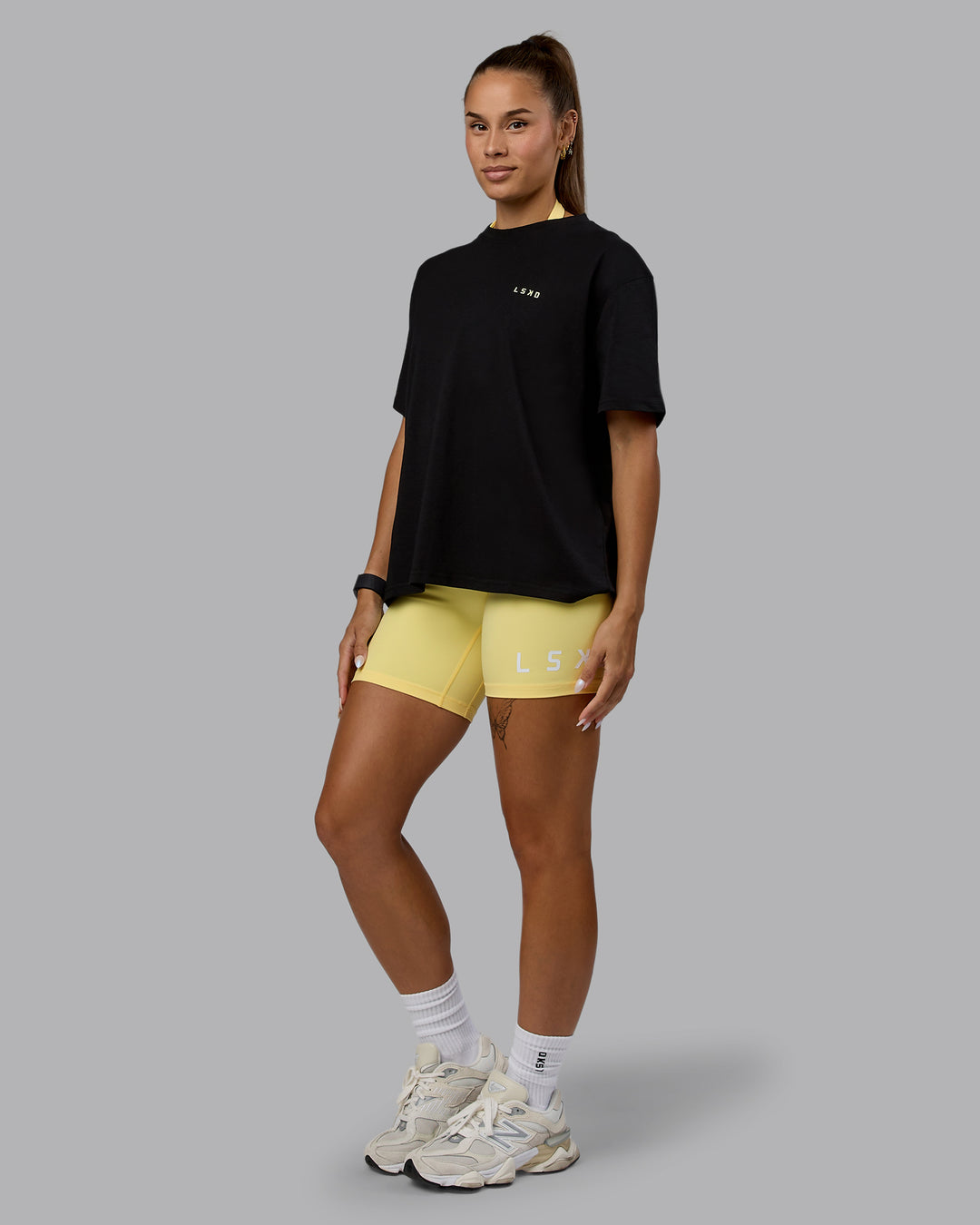 Woman wearing Go-To We Rise FLXCotton Oversized Tee - Black-Glacial Blue